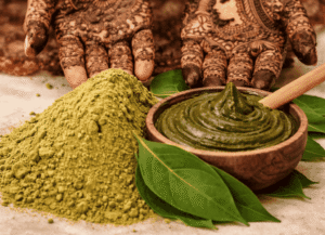 Henna powder and paste with fresh leaves and intricate mehndi designs on hands